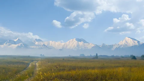 Mountain valley with prairie in dense clouds time lapse scene Stock Footage 240743437