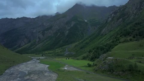 Mountain valley with river stream in cloudy weather — aerial drone view Stock Footage 318467886