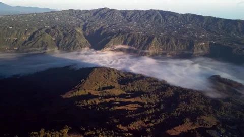 Mountain valley with sea of clouds and rolling hills in golden morning light Stock Footage 334343724