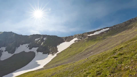 Mountain valley slope in snow under sparkle sun time lapse scene Stock Footage 178921171