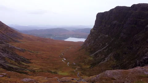 Mountain valley with a small river in autumn in Scotland Stockbeeldmateriaal 258657817