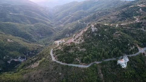 Mountain valley with steep ridges and descending roadway in Greece Video stock 321588018