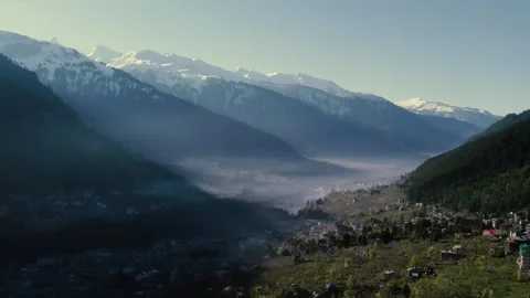 Mountain Valley with Sunlight Rays and Village Symbolizing Peace and Escape Video stock 332547860