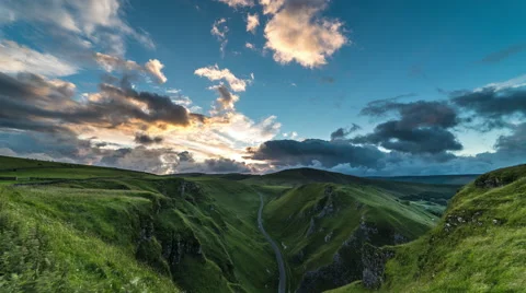 Mountain valley sunset with dramatic sky and clouds in time lapse Stock Footage 65956912