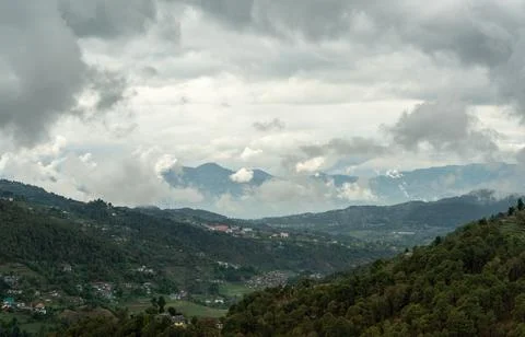 Mountain valley town under a dramatic overcast sky in Himachal Pradesh, India Stock Photos