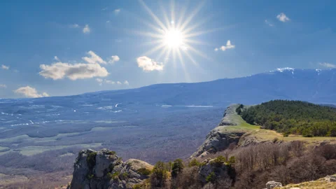 Mountain valley under a sparkle sun time lapse scene Stock Footage 241500321