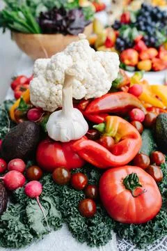 Mountain of vegetables on a lush dining table set for an event Stock Photos