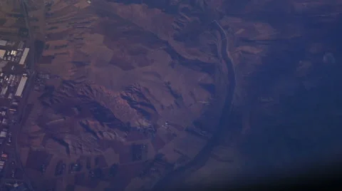 Mountain view from an airplane window above the earth in the blue sky in clouds Stock Footage 68769862