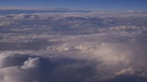 Mountain view from an airplane window above the earth in the blue sky in clouds 库存影片 68770005