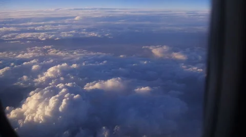 Mountain view from an airplane window above the earth in the blue sky in clouds Video stock 68770061