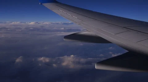 Mountain view from an airplane window above the earth in the blue sky in clouds 스톡 동영상 68770069