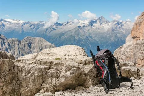 Mountain view with backpack sitting next to rock. Stock Photos