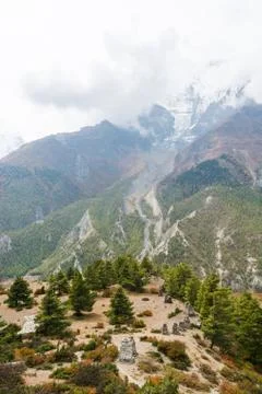 Mountain view with clouds covering a glacier. Stock Photos