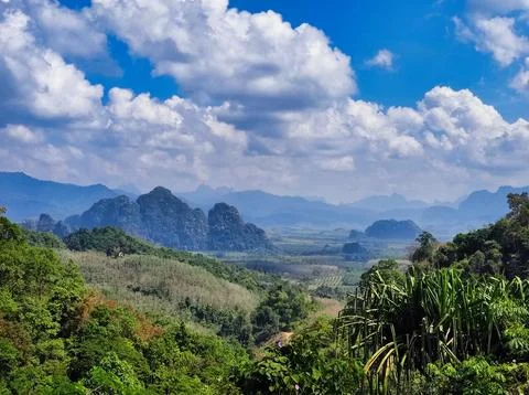 Mountain view with clouds over green landscape and fields during daytime. K.. Stock Photos