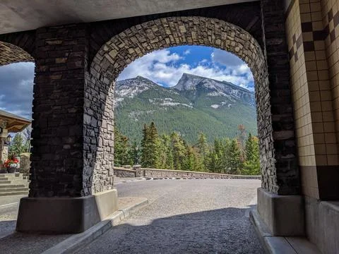 Mountain View Framed by Rustic Stone Archway Overlooking Pine Forest Stock Photos