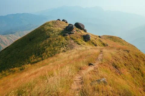 A mountain view full of grass In the evening Stock Photos