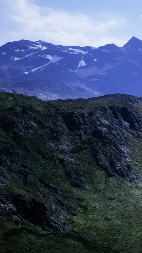 Mountain view with green slopes and snow capped peaks during the day Video stock 333566740