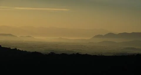 Mountain view from a high place with thick mist in the morning before sunrise Stock Photos