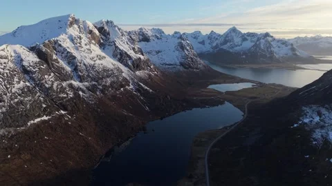 Mountain view with lakes and snow in Norway during sunset near the sea Stock Footage 334774566