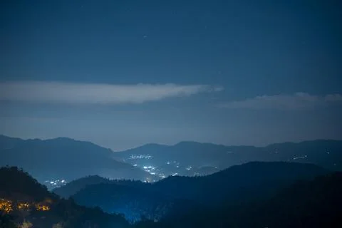 Mountain view with night sky and light from downtown background Stock Photos