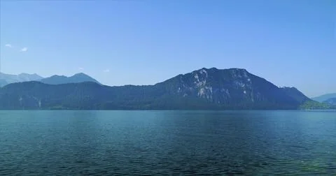 Mountain view over a clear lake during midday in a scenic location with blu.. Fotos Stock