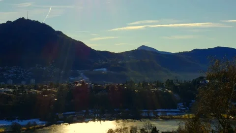Mountain View over Lake Muzzano with Ice in a Sunny Day and Cityscape in Lugano Stock Footage 191954025