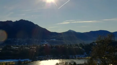 Mountain View over Lake Muzzano with Ice in a Sunny Day and Cityscape in Lugano 動画素材 191954031