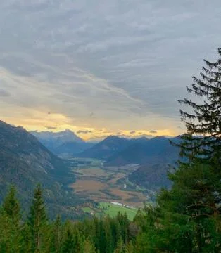 Mountain view over valley with clouds during sunset, alps, Bavaria, Germany Stock Photos