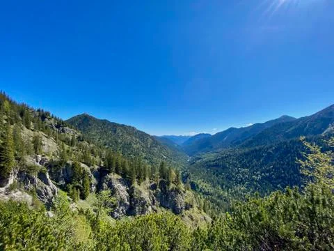 Mountain view over valley with forest, blue sky, alps, Bavaria, Germany Stock Photos