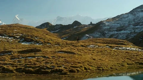 Mountain view with small figure of a man walking with backpack Stock Footage 201164948
