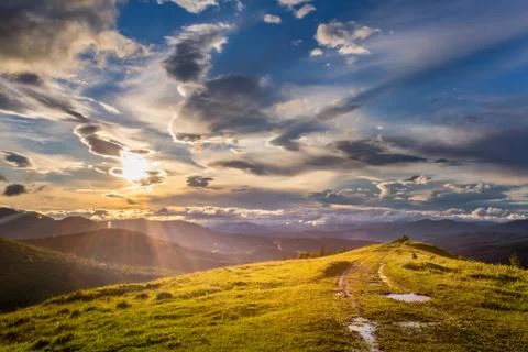 Mountain view at sunset with cloudy sky Stock Photos