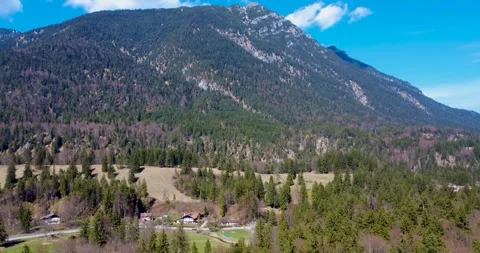 Mountain View With Trees and a Field Under Clear Sky Near a Small Town in Stock Footage 334859020
