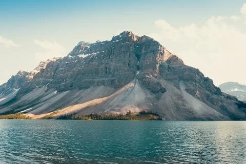 Mountain view: vast mountain range backdrop for calm, clear blue lake Stock Photos