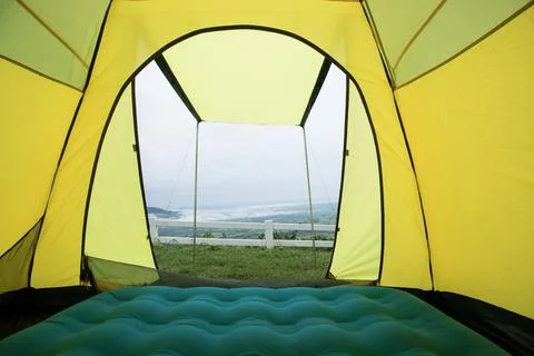Mountain View from window camping tent  trough cloudy sky Stock Photos
