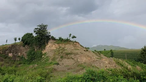 Mountain views with a rainbow background in the sky Видео 335113436