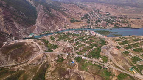 Mountain village fields and blue reservoir in Dagestan aerial view Stock Footage 341184199