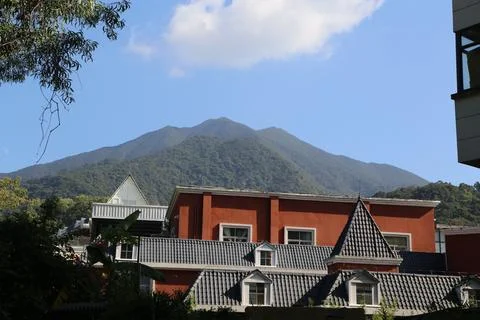 A mountain is visible in the background of a red building Stock Photos