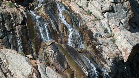 Mountain water flows down the rocks on a hot day Stock-Footage 103955085