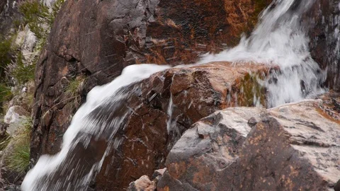 Mountain Water Rushing over Large Pink and Grey Rocks 스톡 동영상 97361124