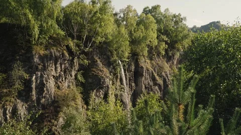 Mountain waterfall among rocks and plants Video stock 287218850