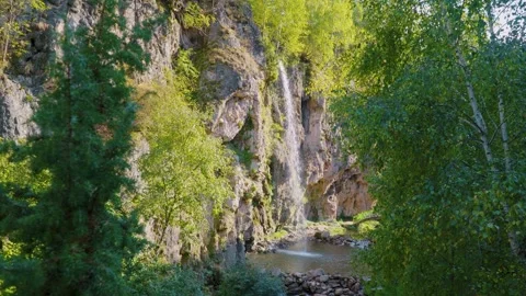 Mountain waterfall among rocks and plants Video stock 289101011
