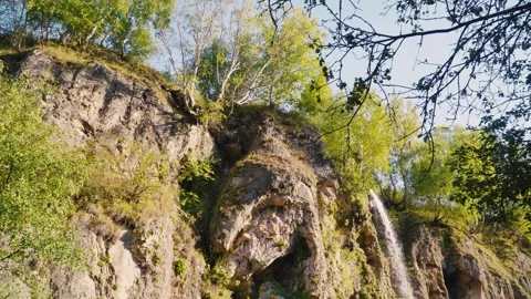 Mountain waterfall among rocks and plants Stock Footage 303558611