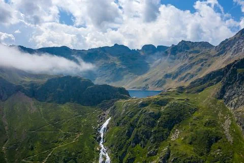 Mountain waterfall and blue lake, Pyrenees aerial Stock Photos