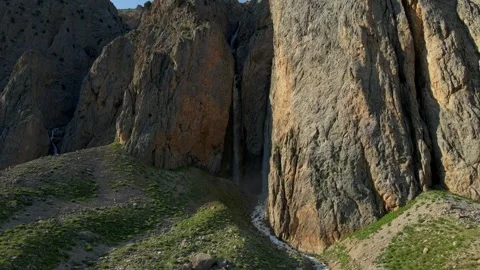 A mountain with a waterfall and a path leading to it Stock Footage 330533693