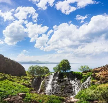 Mountain waterfall with blue cloudy sky Fotos Stock