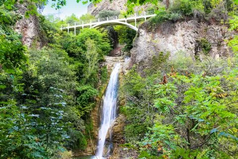 Mountain waterfall with bridge Stock Photos