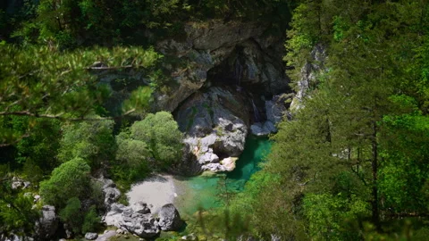 Mountain waterfall cascading into emerald turquoise pool at Pozze Smeraldine Stock Footage 342070912