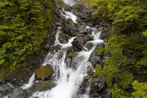 Mountain Waterfall Cascading Over Dark Rocky Slope Stock Photos
