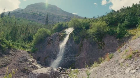 Mountain waterfall flowing down rocky cliff Video stock 316193972