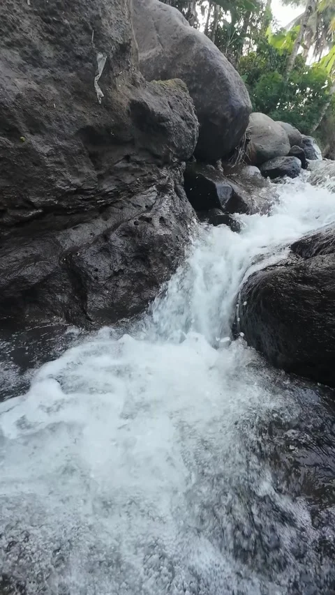 Mountain Waterfall Flowing Through Dark Rocks in Vertical 4K Nature Footage Stock Footage 336748638